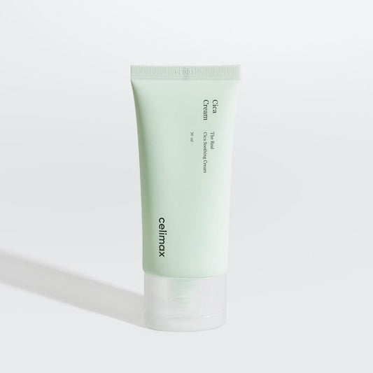 Product imageCelimax The Real Cica Soothing Cream lifestyle flat lay on white marble with centella asiatica leaves and white 